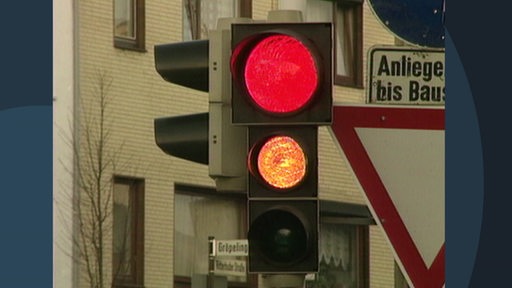 Eine rot leuchtende Ampel.