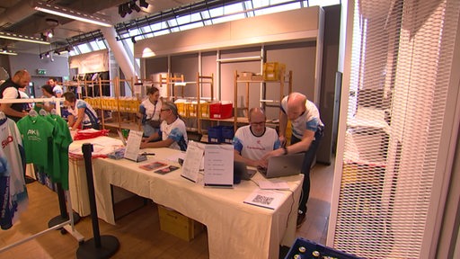 Mitarbeiter des Bremen-Marathons sind im Anmeldungsbüro beschäftigt.