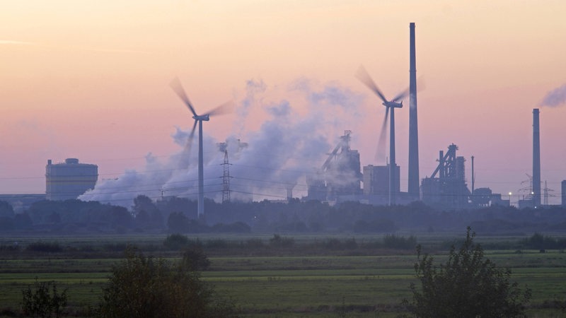 Stahlwerk Arcelor Mittal und Windraeder im Morgenrot in Bremen