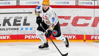 Eishockey-Spieler Maxim Rausch von den Fischtown Pinguins führt in einem Spiel in den Puck.