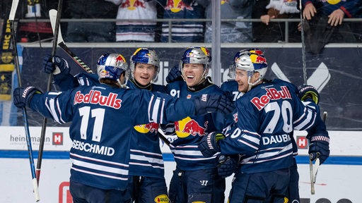 Eishockey-Spieler des EHC München umarmen sich jubelnd nach einem Treffer gegen Wolfsburg in den Play-offs.