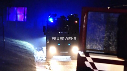 Auf dem Gelände eines Recyclingbetriebs steht ein Feuerwehrauto.