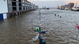 Schilder und Gebäude stehen unter Wasser.