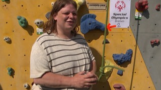 Vanessa Giesenberg steht vor der Kletterwand.