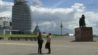 Wettermoderatorin Anastasia Hill und ein Zuschauer stehen in Bremerhaven.