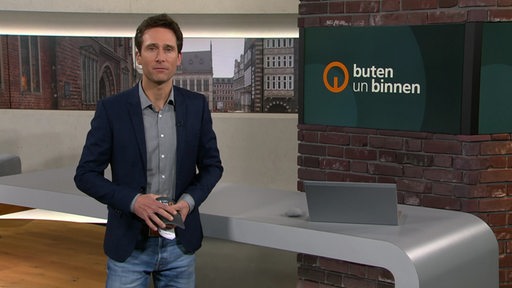 Zu sehen ist der Moderator Janos Kereszti im Studio von buten un binnen.