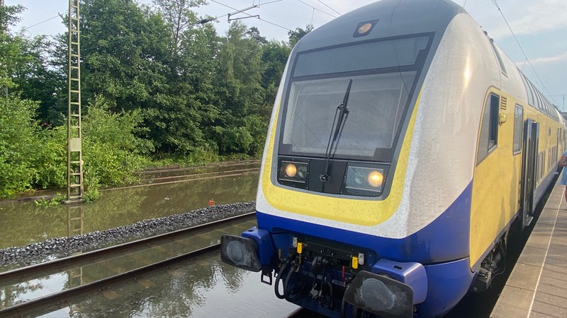 Ein Metronom steht auf einer überschwemmten Bahnstrecke