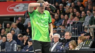 Werders Tischtennis-Profi Mattias Falck wischt sich während des Pokal-Halbfinals in Neu-Ulm frustriert den Schweiß mit dem Handrücken von der Stirn.