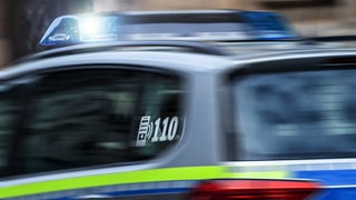 Das Blaulicht auf einem Polizeiauto blinkt.