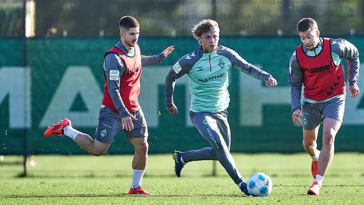 Isak Hansen-Aaroen, Romano Schmid und Mitchell Weiser kämpfen im Training um den Ball.